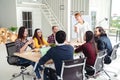 Group of multiracial young creative team talking, laughing and brainstorming in meeting at modern office concept. Royalty Free Stock Photo