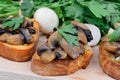 Group of mushroom bruschetta on chopping board