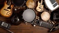 Group of musical instruments including a guitar, drum, keyboard, tambourine. Top view Royalty Free Stock Photo