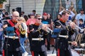 Group of musicians is performing a lively show on the public street during a parade in Dartmouth