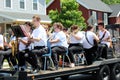 Several young people in band on wagon being drawn through town in All Things Oz Parade, Chittenango, New York, 2018