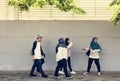 A group of Muslim students walking on the street