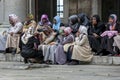 A group of Muslim women wearing colourful headscarves.