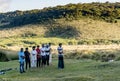 Group of muslims praying on the lawn during sunset time