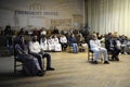 Group of Muslims sitting in conference hall celebrating Islamic holiday Mawlid