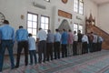 Group of muslims standing at prayer in mosque