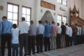 Group of muslims standing at prayer in mosque