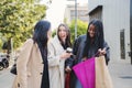 Group of mutiethnic happy young women suprised looking inside of a shopping bag outdoors. Three shopaholic girls Royalty Free Stock Photo