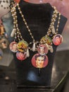 Group of Necklaces with Coloured Beads and Frida Kahlo Effigy hanging on a Display Unit