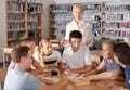 Group of nice schoolers discussing with teacher Royalty Free Stock Photo