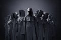 Group of nine scary figures in hooded cloaks