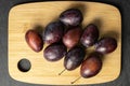 Sweet purple plum on grey stone