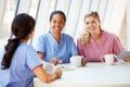 Group Of Nurses Chatting In Modern Hospital Canteen Royalty Free Stock Photo