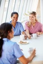 Group Of Nurses Chatting In Modern Hospital Canteen Royalty Free Stock Photo