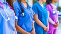 A group of nurses standing in a line with their hands in their pockets Royalty Free Stock Photo