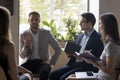 Group of office employees listen to boss at briefing