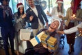 Group of office workers celebrating Christmas.Young smiling man and woman in santa hat at Xmas party Royalty Free Stock Photo