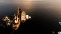 Group of Old Cargo Ships, Tugboats, Fishing Ships and Small Boats in the Coast near Rocks. Royalty Free Stock Photo