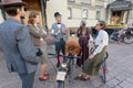 Group of old-fashioned style people in vintage clothing talking at the cycling festival in Europe
