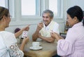 group of old pensioners playing cards at home Royalty Free Stock Photo