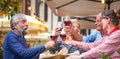 Group of old people eating and drinking outdoor - Senior couples having fun together Royalty Free Stock Photo