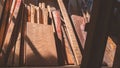 Group of the old remaining wooden timbers material used leaning against the wall inside of storage house Royalty Free Stock Photo