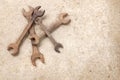 Copy space group old rusted spanner wrenches Mechanic tool on grey concrete background