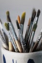 Group of old used paintbrushes in jar. Royalty Free Stock Photo