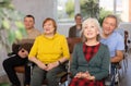 Group of older students sitting and listening at lesson