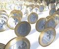 Group of one euro coins rolling past the viewer, in focus front to back Royalty Free Stock Photo