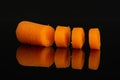 Peeled baby carrot isolated on black glass Royalty Free Stock Photo