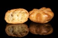 Golden baked profiterole isolated on black glass