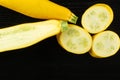 Fresh Raw yellow zucchini on black wood Royalty Free Stock Photo