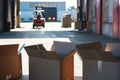 a group of open boxes stacked, warehouse forklift in the distance Royalty Free Stock Photo