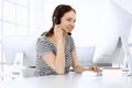 Group of operators at work. Call center. Focus on beautiful woman receptionist in headset at customer service. Business Royalty Free Stock Photo