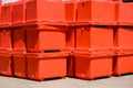 Group of orange foldable ice buckets stack on courtyard outside of storage Royalty Free Stock Photo