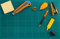 Group of office supplies on cutting mat, flat lay picture Royalty Free Stock Photo