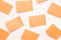 A group of orange post-it notes memo sticker papers note pads on the wall