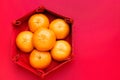 Group of orange tangerine in Chinese pattern tray on red table t