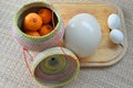 Group of oranges in bamboo container with duck egg and ostrich e Royalty Free Stock Photo