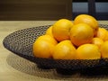 Group of oranges in round tray on wooden table Royalty Free Stock Photo