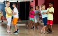 Group of ordinary children dancing salsa dance