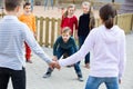 Group of ordinary children playing red rover