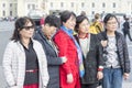 Group of Oriental women, tourists from Asia posing for photos at the Palace square of St. Petersburg, Russia, 2018
