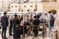 A group of Orthodox believers Jews conduct a joint prayer with the Torah Scrolls near the Kotel in the Old Town of Jerusalem in Royalty Free Stock Photo