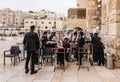 A group of Orthodox believers Jews conduct a joint prayer with the Torah Scrolls near the Kotel in the Old Town of Jerusalem in Royalty Free Stock Photo