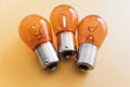 Group of p21 12v car rear brake light bulbs isolated on yellow background