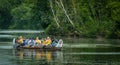 Group paddling down the Long Pond at the Toronto Islands. Tourists paddling on canoe on the river exploring territories Royalty Free Stock Photo