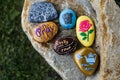 Group of painted rocks on a small boulder