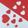 Group of paper Hearts layed on devided white and red background. Royalty Free Stock Photo